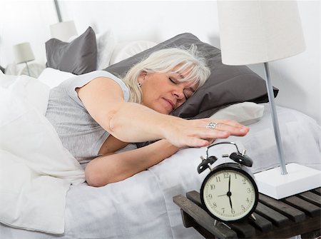 simsearch:400-04903640,k - Sleeping woman turn off the alarm clock Stock Photo - Budget Royalty-Free & Subscription, Code: 400-08033675