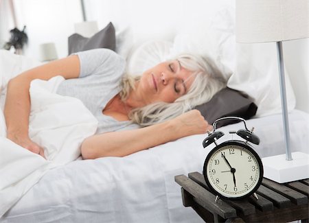 simsearch:400-04903640,k - Sleeping woman in front of the alarm clock Stock Photo - Budget Royalty-Free & Subscription, Code: 400-08033671