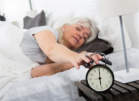 simsearch:400-04903640,k - Sleeping woman turn off the alarm clock Stock Photo - Budget Royalty-Free & Subscription, Code: 400-08033673