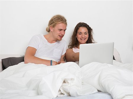 Married couple with a laptop in bed Stock Photo - Budget Royalty-Free & Subscription, Code: 400-08033694