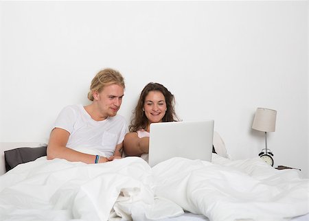 Married couple with a laptop in bed Stock Photo - Budget Royalty-Free & Subscription, Code: 400-08033695