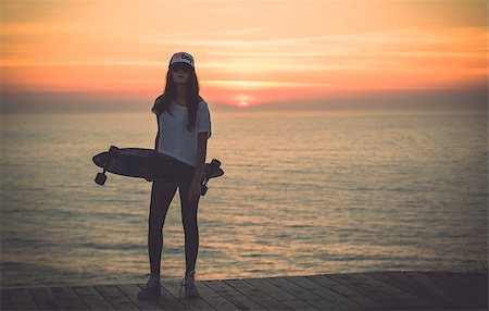 Beautiful and fashion young woman posing with a skateboard Stock Photo - Budget Royalty-Free & Subscription, Code: 400-08033869