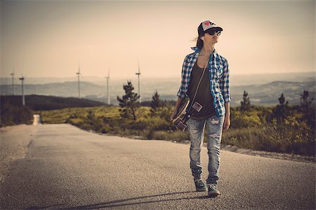 simsearch:400-07507525,k - Beautiful young woman walking and holding a skateboard Stock Photo - Budget Royalty-Free & Subscription, Code: 400-08033860