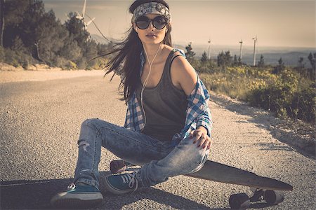 simsearch:400-07507525,k - Beautiful young woman sitting over a skateboard Stock Photo - Budget Royalty-Free & Subscription, Code: 400-08033862