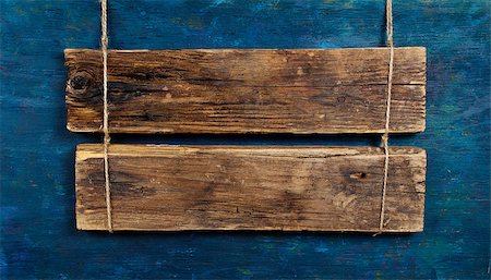 blank wooden signboard on aged wooden blue wall Fotografie stock - Microstock e Abbonamento, Codice: 400-08044108