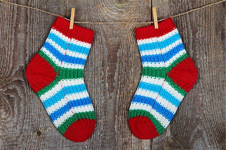 socks hanging clothesline - Colorful socks hanging on the clothesline on old wooden background Stock Photo - Budget Royalty-Free & Subscription, Code: 400-08044158