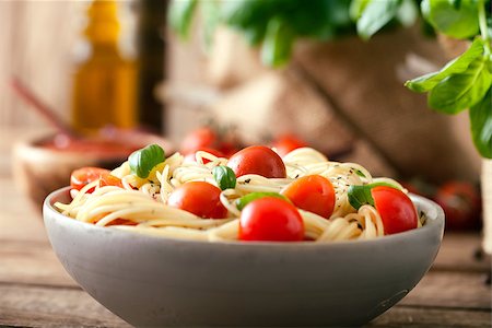 delicious pasta - Italian cuisine. Pasta with olive oil, garlic, basil and tomatoes. Spaghetti with tomatoes Stock Photo - Budget Royalty-Free & Subscription, Code: 400-08045058