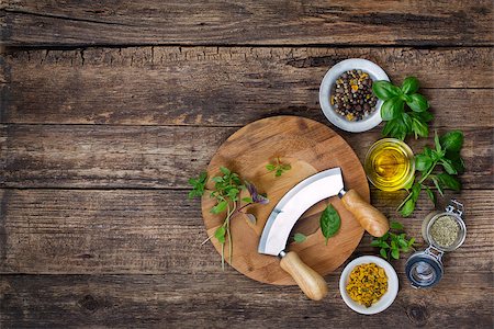 food menu board - fresh herbs and spices on cutting board with a mezzaluna. Top view Stock Photo - Budget Royalty-Free & Subscription, Code: 400-08045774