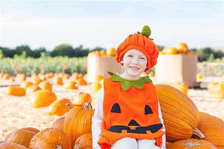 simsearch:400-07211170,k - little excited kid in halloween pumpkin costume enjoying time at pumpkin patch Photographie de stock - Aubaine LD & Abonnement, Code: 400-08046451