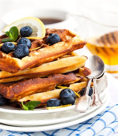 simsearch:400-07917638,k - Lemon blueberry waffles with honey, zest, fresh berries and cup of tea, soft focus Stock Photo - Budget Royalty-Free & Subscription, Code: 400-08047631