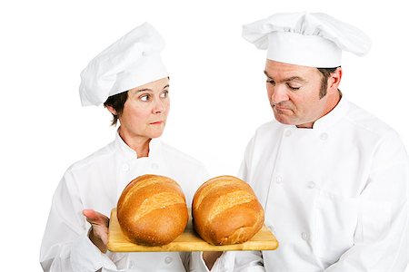 One baker evaluates another baker's fresh Italian bread.  Isolated on white. Stock Photo - Budget Royalty-Free & Subscription, Code: 400-08040637