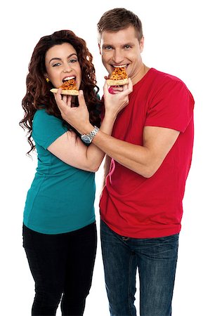 simsearch:400-08107342,k - Adorable love couple enjoying pizza pie together. Both making each other enjoy pizza piece Stock Photo - Budget Royalty-Free & Subscription, Code: 400-08042604