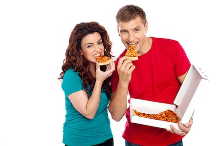 simsearch:400-08107342,k - Adorable young couple relishing yummy pizza. Indoor studio shot Stock Photo - Budget Royalty-Free & Subscription, Code: 400-08042606