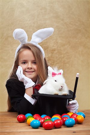 simsearch:400-08036285,k - Young magician after successfully conjuring an easter rabbit - sitting with satisfaction Stockbilder - Microstock & Abonnement, Bildnummer: 400-08043105