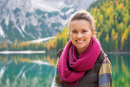 simsearch:400-08054028,k - Portrait of a smiling brunette. In the background, autumn colours and the Dolomite mountains are reflecting in the still water of Lake Bries. Fall colours and foliage. Photographie de stock - Aubaine LD & Abonnement, Code: 400-08054029