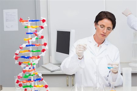 simsearch:400-08055390,k - Scientist pouring chemical fluid in funnel in laboratory Stock Photo - Budget Royalty-Free & Subscription, Code: 400-08054847