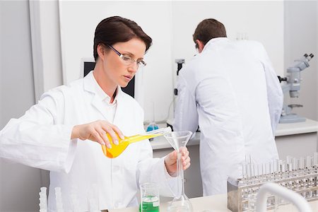 simsearch:400-08055357,k - Scientists working attentively with test tube and computer in laboratory Stock Photo - Budget Royalty-Free & Subscription, Code: 400-08054856