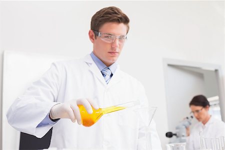 simsearch:400-08055390,k - Scientists working attentively with test tube and microscope in laboratory Stock Photo - Budget Royalty-Free & Subscription, Code: 400-08054858