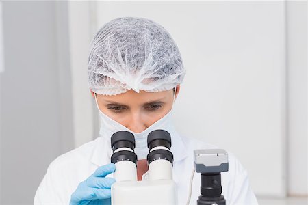 simsearch:6109-08389507,k - Scientist working attentively with microscope in laboratory Stock Photo - Budget Royalty-Free & Subscription, Code: 400-08054888