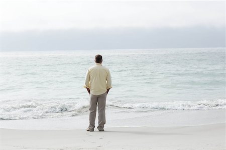 Thoughtful man standing by the sea at the beach Stock Photo - Budget Royalty-Free & Subscription, Code: 400-08055261