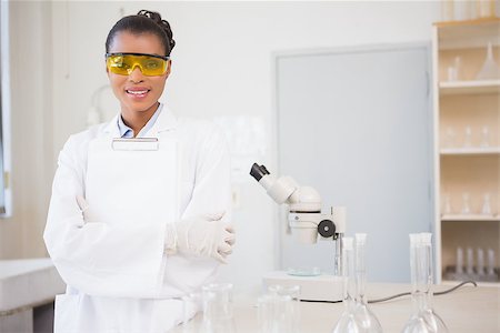 simsearch:400-08055390,k - Smiling scientist looking at camera and holding clipboard in laboratory Stock Photo - Budget Royalty-Free & Subscription, Code: 400-08055366