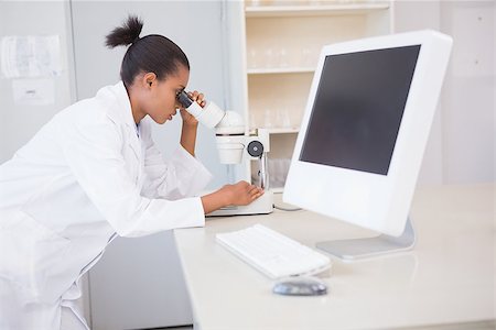 simsearch:400-08055357,k - Scientist looking through a microscope in laboratory Stock Photo - Budget Royalty-Free & Subscription, Code: 400-08055362