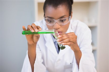 simsearch:400-08055396,k - Concentrated scientist doing scientific experiment in laboratory Stock Photo - Budget Royalty-Free & Subscription, Code: 400-08055412