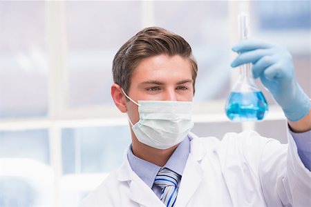 simsearch:400-08055390,k - Scientist examining beaker with blue fluid in laboratory Stock Photo - Budget Royalty-Free & Subscription, Code: 400-08055435