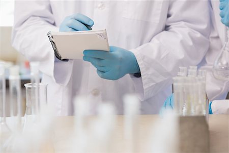 simsearch:400-08055396,k - Scientist taking notes in laboratory Stock Photo - Budget Royalty-Free & Subscription, Code: 400-08055436