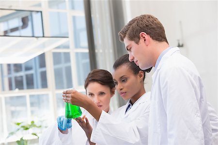 simsearch:400-08055396,k - Scientists analyzing beakers with chemical fluid in laboratory Stock Photo - Budget Royalty-Free & Subscription, Code: 400-08055440