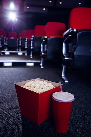 Empty rows of red seats with pop corn and drink on the floor at the cinema Stock Photo - Budget Royalty-Free & Subscription, Code: 400-08055629