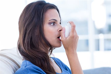 photo inhaler person - Beautiful brunette using inhaler in the living room Stock Photo - Budget Royalty-Free & Subscription, Code: 400-08055829