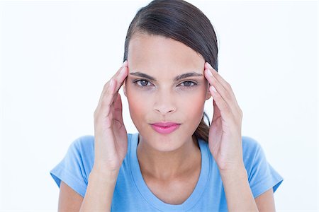 simsearch:400-07778671,k - Pretty woman with headache touching her temples looking at camera on white background Fotografie stock - Microstock e Abbonamento, Codice: 400-08056004