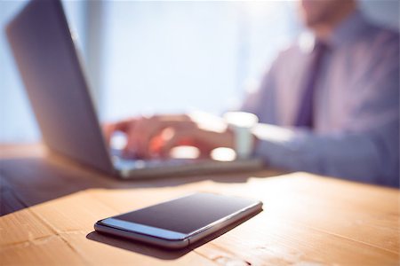 screen shot of phone - Businessman using laptop at desk shot in studio Stock Photo - Budget Royalty-Free & Subscription, Code: 400-08056439