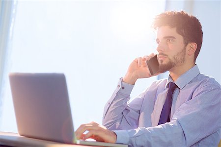 simsearch:400-04168729,k - Businessman using laptop at desk shot in studio Stock Photo - Budget Royalty-Free & Subscription, Code: 400-08056433