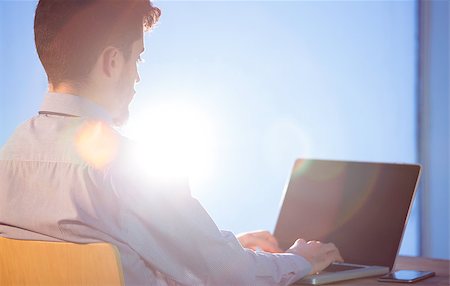 simsearch:400-04168729,k - Businessman using laptop at desk shot in studio Stock Photo - Budget Royalty-Free & Subscription, Code: 400-08056454