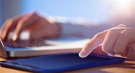 simsearch:400-04168729,k - Businessman using laptop and tablet at desk shot in studio Stock Photo - Budget Royalty-Free & Subscription, Code: 400-08056450