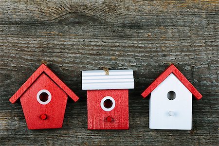 simsearch:400-06520273,k - Three birdhouses painted with red and white colors on old wooden background Stock Photo - Budget Royalty-Free & Subscription, Code: 400-08051423