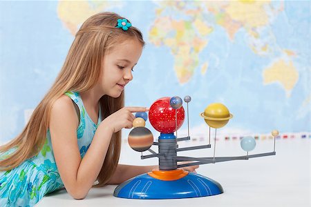 Little girl studies the solar system in geography class - looking at the scale model of planets Stock Photo - Budget Royalty-Free & Subscription, Code: 400-08052488