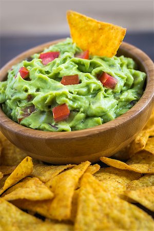 eating chips dip - Guacamole in Wooden Bowl with Tortilla Chips Stock Photo - Budget Royalty-Free & Subscription, Code: 400-08052989