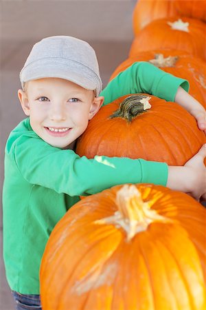 simsearch:400-07211170,k - little smiling boy holding huge pumpkin at pumpkin patch Photographie de stock - Aubaine LD & Abonnement, Code: 400-08053086