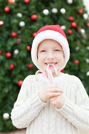 silly winter boy - excited little boy in santa's hat holding candy canes at christmas time Stock Photo - Budget Royalty-Free & Subscription, Code: 400-08053081