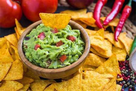 eating chips dip - Guacamole in Wooden Bowl with Tortilla Chips and Ingredients Stock Photo - Budget Royalty-Free & Subscription, Code: 400-08053902