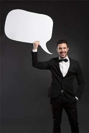 simsearch:614-06442655,k - Handsome latino young man holding a speach balloon Photographie de stock - Aubaine LD & Abonnement, Code: 400-08074115