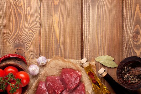 steak on paper - Raw fillet beef steak and spices on wooden table. Top view with copy space Stock Photo - Budget Royalty-Free & Subscription, Code: 400-08074236