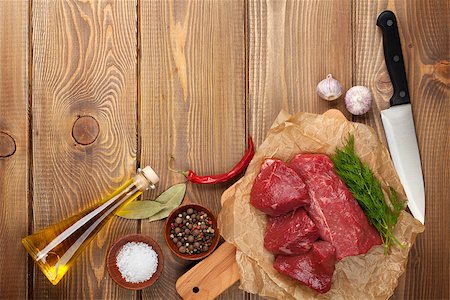 steak on paper - Raw fillet beef steak and spices on wooden table. Top view with copy space Stock Photo - Budget Royalty-Free & Subscription, Code: 400-08074238