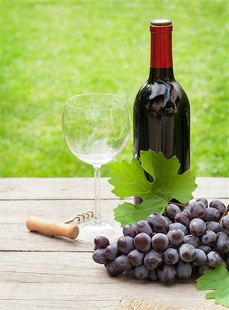 Red wine glass and bottle with bunch of grapes in sunny garden Stock Photo - Budget Royalty-Free & Subscription, Code: 400-08074276