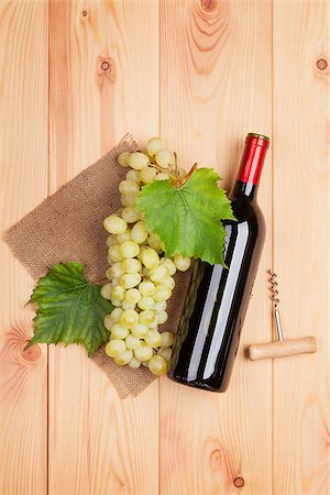 simsearch:400-08110621,k - Red wine bottle and bunch of white grapes on wooden table background Stock Photo - Budget Royalty-Free & Subscription, Code: 400-08074280