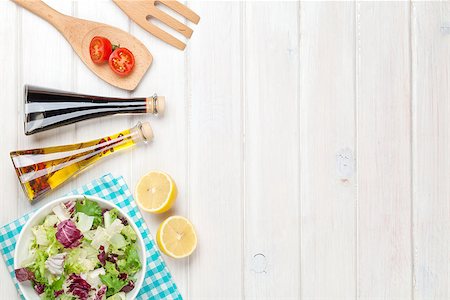simsearch:400-06485512,k - Fresh healthy salad and condiments over white wooden table. View from above with copy space Stock Photo - Budget Royalty-Free & Subscription, Code: 400-08074315