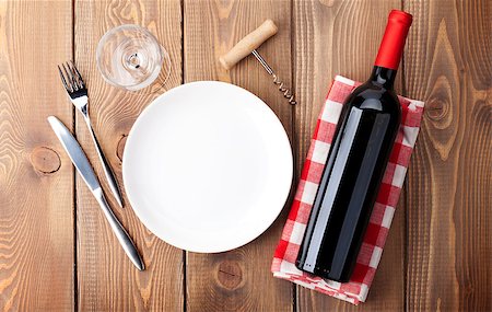 simsearch:400-07933837,k - Table setting with empty plate, wine glass and red wine bottle. Top view over rustic wooden table background Stockbilder - Microstock & Abonnement, Bildnummer: 400-08074323